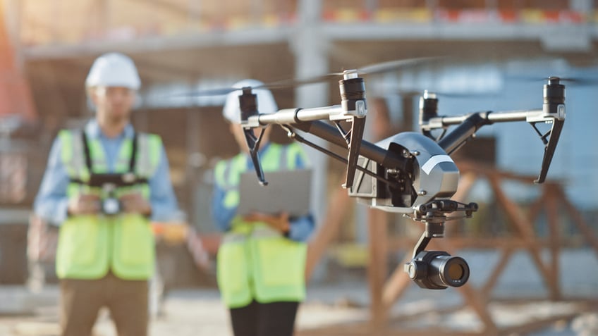建筑工人操作无人机在一个建筑工地